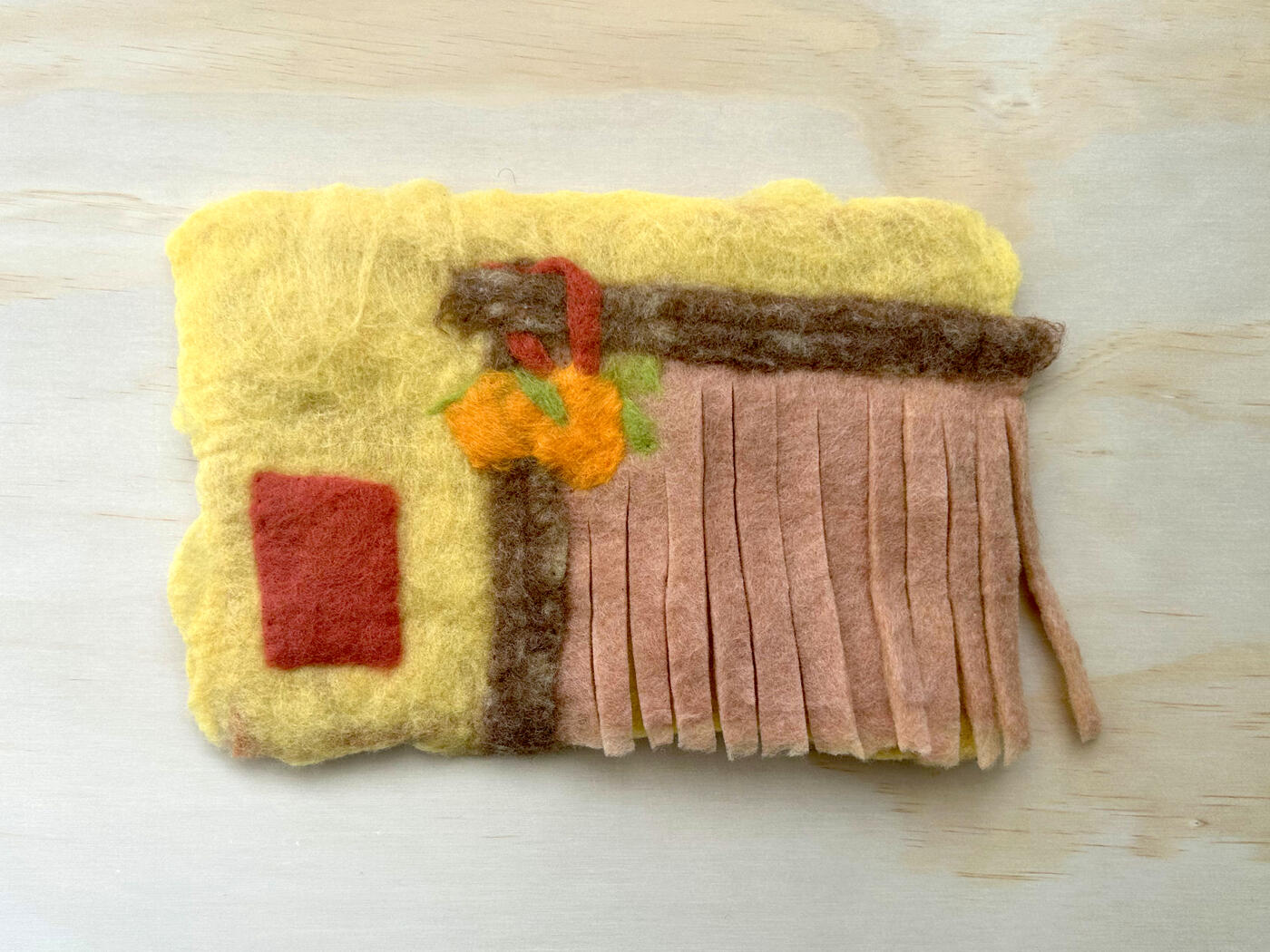 hang an orange at your door, 2026, Merino and Ontario romney wool with natural dyes, size: 8.25" x 12.25"